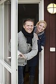 Portrait of happy couple standing together at front door