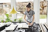 Female architect working at table in home office