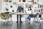 Architects working at table in home office