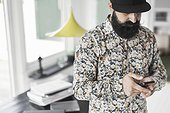 Man using mobile phone at home office