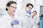 Female scientists examining chemical at laboratory