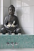 Buddha figurine with blossoms