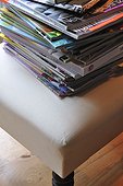 Stack of magazines on chair