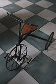 Antique tricycle on tiled floor