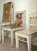 Teddy bear on wooden chair