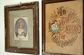 Two antique pictures in frames at wall