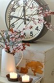 Blooming branches, candles and clock
