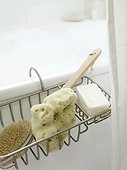 Sponge, soap and brush at bathtub