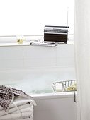 Bathtub and radio on windowsill