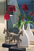 Flowers and horse figurines at mirror