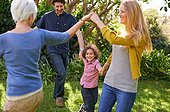 Youve got to have fun together. Shot of a happy multi-generational family playing outside in the garden.