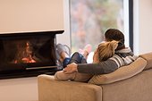 Young couple  in front of fireplace