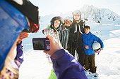 Girl photographing family, Les Arcs, Haute-Savoie, France
