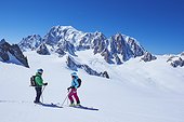 Female and male skiers talking on Mont Blanc massif, Graian Alps, France