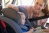 My childs safety is very important. Portrait of a mother fastening her baby boy safely in a car seat.