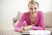 portrait of young woman at home working on personal finance