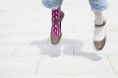 detail of woman wearing different socks