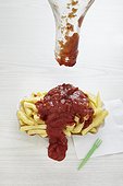 ketchup spilled over portion of chips
