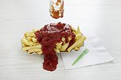 ketchup spilled over portion of chips