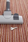 vacuum cleaner accidentally vacuuming key on carpet