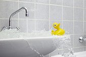 overflowing sink in bathroom with yellow rubber duck