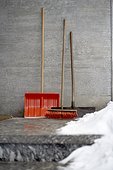 still life of snow shovel broom and shovel in winter