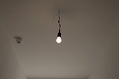 light bulb hanging from ceiling in empty flat