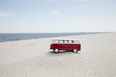 vw toy car on sandy beach