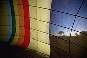 trees at sunset portrayed through a clear cloth panel on a hot air balloon; kenya