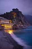 a building illuminated at night along the coast; camogli liguria italy
