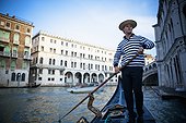 a gondolier rowing a gondola; venice venezia italy