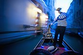 a gondolier rowing a gondola; venice venezia italy