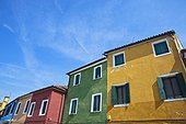 buildings in a row painted all different bright colors; burano venezia italy