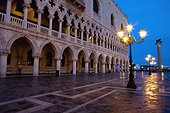 a street light illuminated at night in front of a building; venice venezia italy