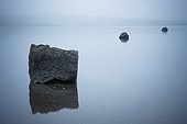 rocks reflected in the tranquil water; iceland