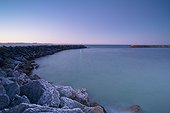 tranquil scene of blue water along the coast at sunset; new zealand