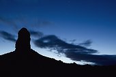 silhouette of a rock formation at dusk; trona california united states of america