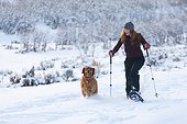 Woman snowshoeing with her dog, Park City, Utah, Winter