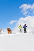 Couple snowshoeing at Park City with their Golden Retriever, Utah, Winter