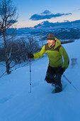 Man snowshoeing in the evening at Park City, Utah, Winter