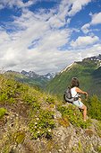 Female hiker on Bird Ridge viewing scenery, Southcentral Alaska, Summer
