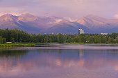 Near midnight view of Chugach Mountains and buildings in downtown Anchorage from Westchester Lagoon, Southcentral Alaska, Summer