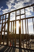 Wooden frame with sunburst in middle at construction site.
