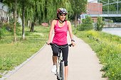 Happy Young Woman Riding Bicycle