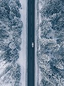 Country Road Going Through The Beautiful Snow Covered Landscapes. Aerial View.
