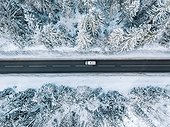 Aerial View Of Winter Road And Forest With Snow Covered Trees In Finland