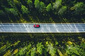 Aerial View Of Red Car On A Country Road In Forest In Finland