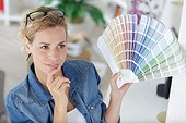 Woman Choses Color From Color Swatches Book