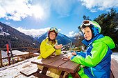 Mom And Sun Enjoy Lunch After Ski In Mountains