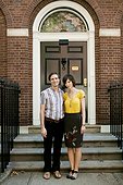 USA, New York, New York City, Portrait of young couple in front of apartment building